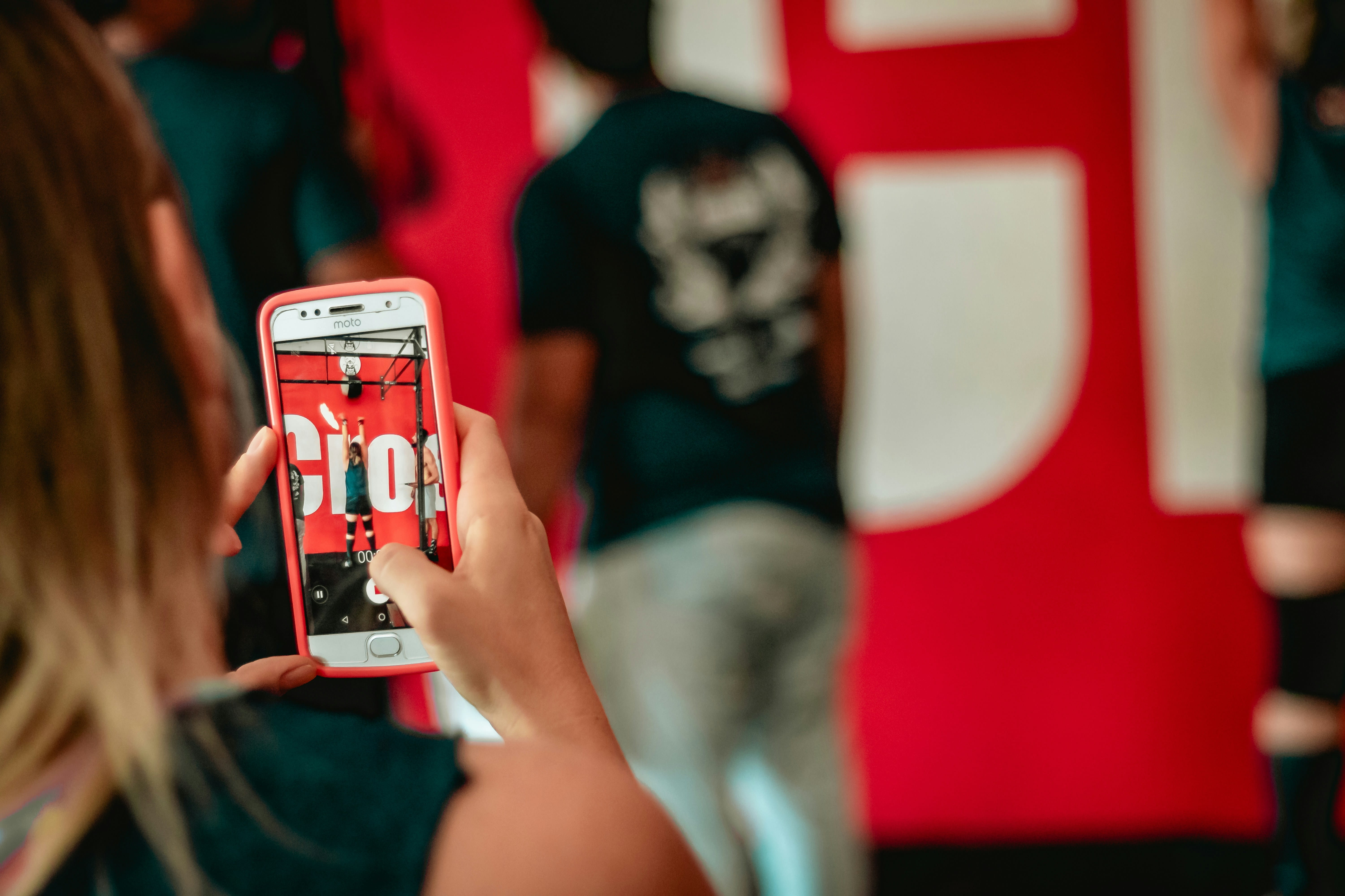 A videographer filming a branded event as an athlete performs