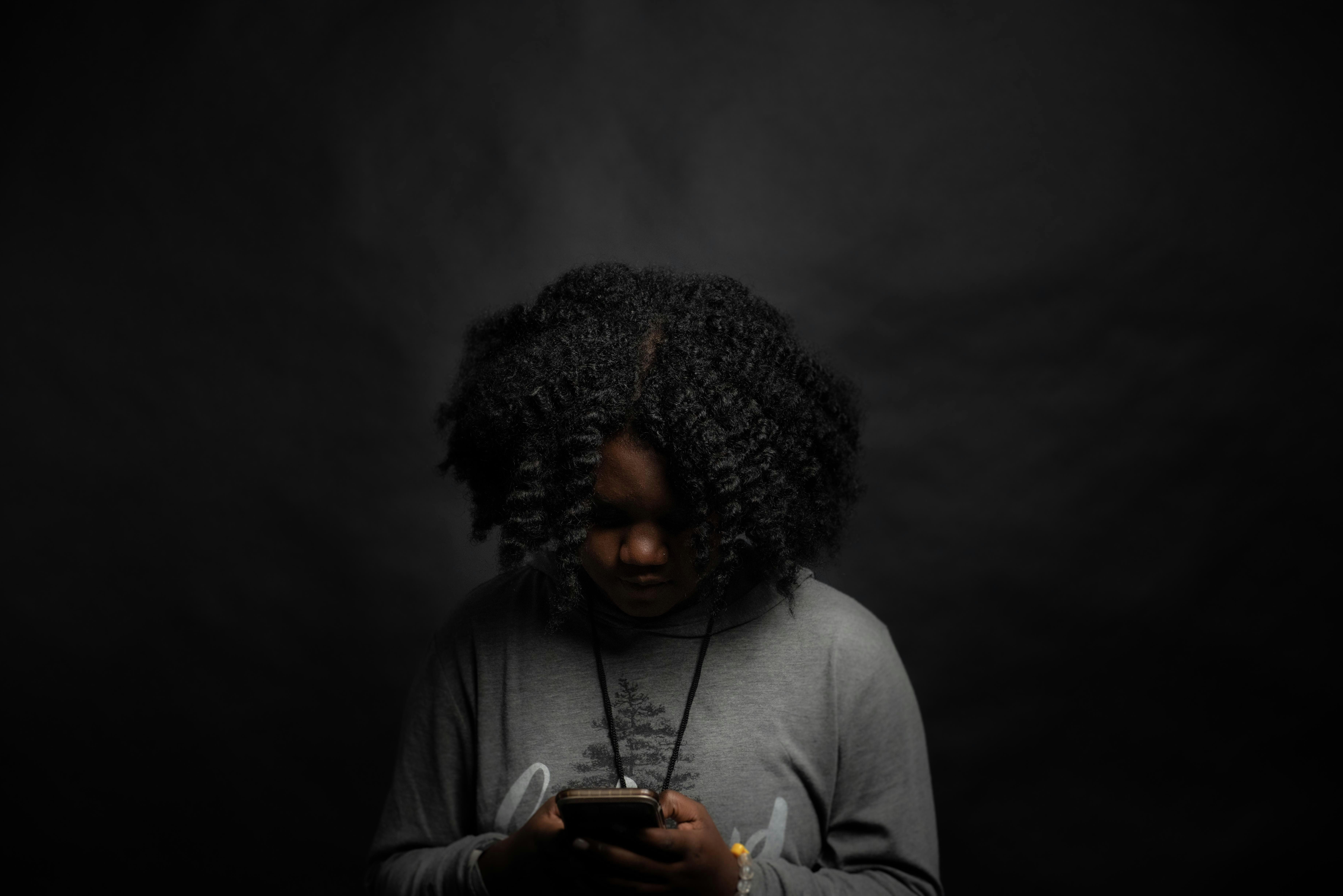 A reader absorbed in a story on her phone