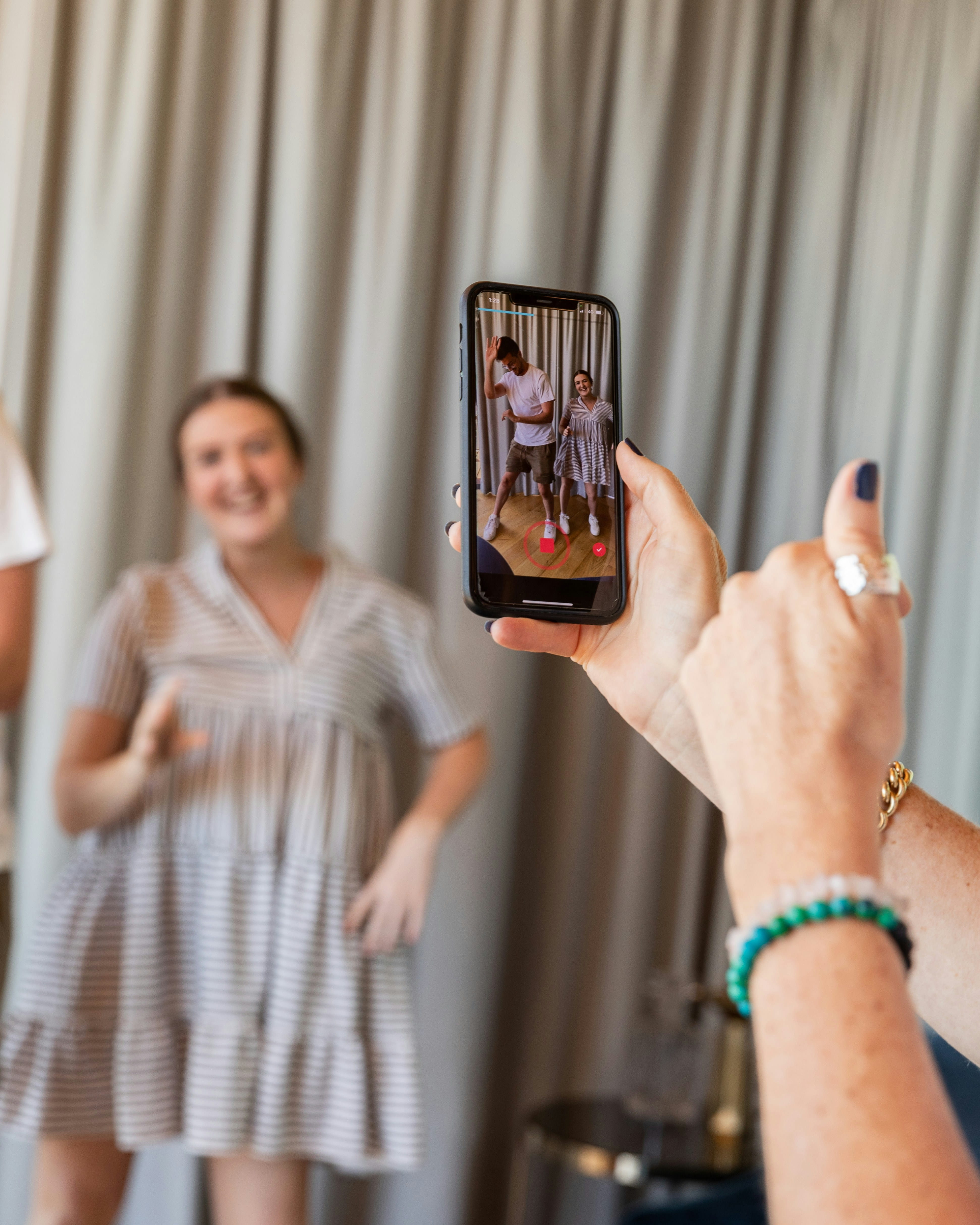 A creator being filmed dancing while making content for her audience